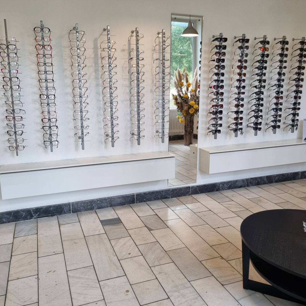 Interiér prevádzky Pressburg Optik na Herlianskej 45 — steny s okuliarmi